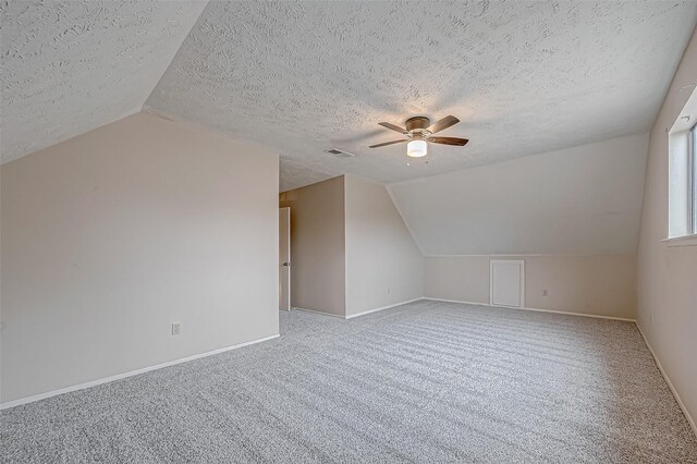 bonus room featuring baseboards, visible vents, carpet floors, and lofted ceiling