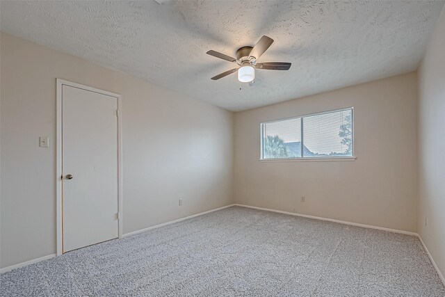 unfurnished room featuring carpet floors, a textured ceiling, and ceiling fan