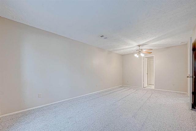 spare room with visible vents, a ceiling fan, a textured ceiling, baseboards, and light colored carpet