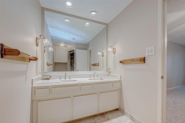 bathroom with vanity and a textured ceiling