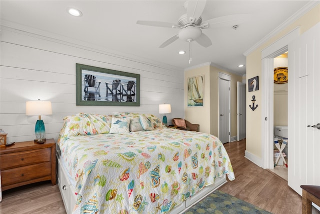 bedroom featuring ornamental molding, hardwood / wood-style floors, and ceiling fan