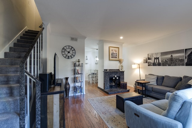 living room with hardwood / wood-style floors and crown molding