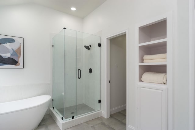 bathroom with built in shelves and plus walk in shower