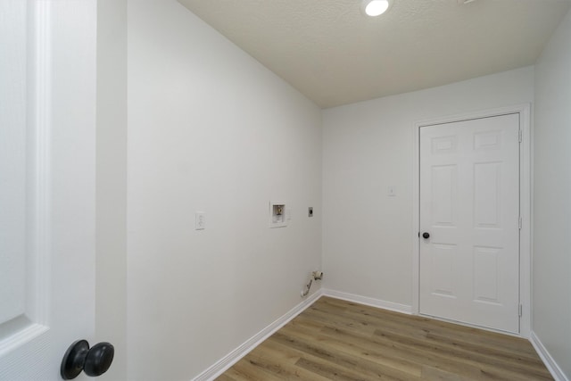 clothes washing area featuring washer hookup, light wood-type flooring, a textured ceiling, and electric dryer hookup