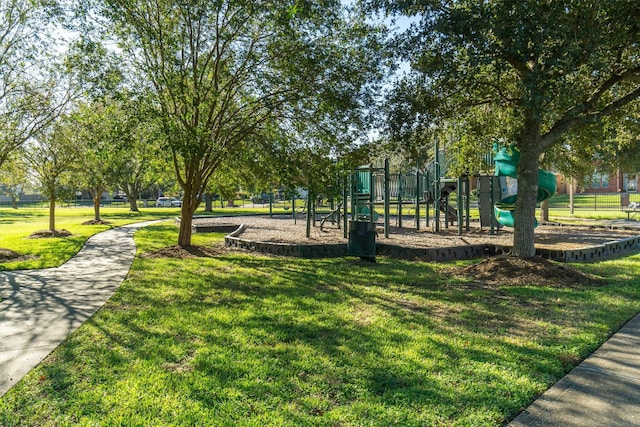 surrounding community featuring a playground and a yard