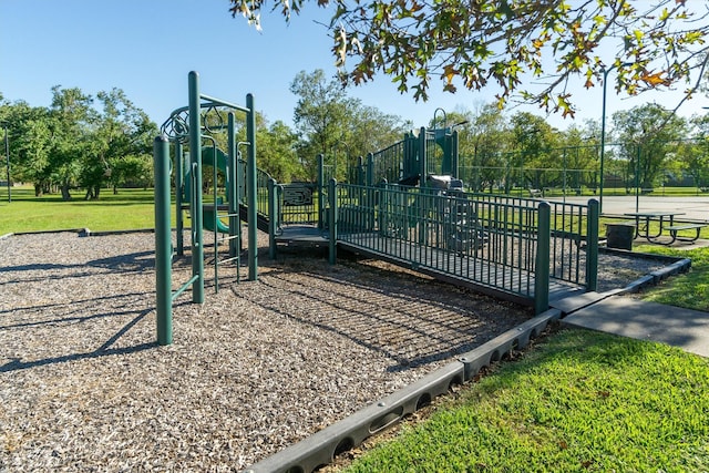 view of jungle gym featuring a lawn