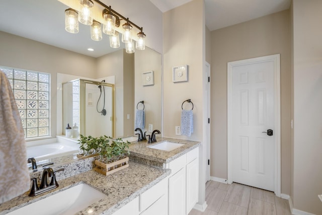 19106 High Canyon Ln, Tomball, TX 77377 - full bathroom with a shower stall, double vanity, baseboards, and a bath