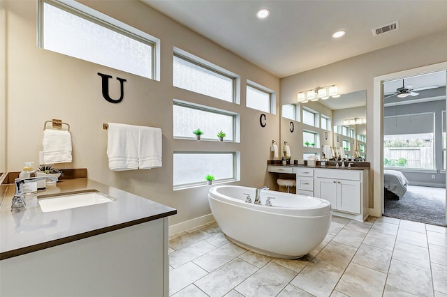 bathroom with vanity and a washtub