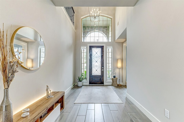 foyer entrance featuring a high ceiling and a notable chandelier