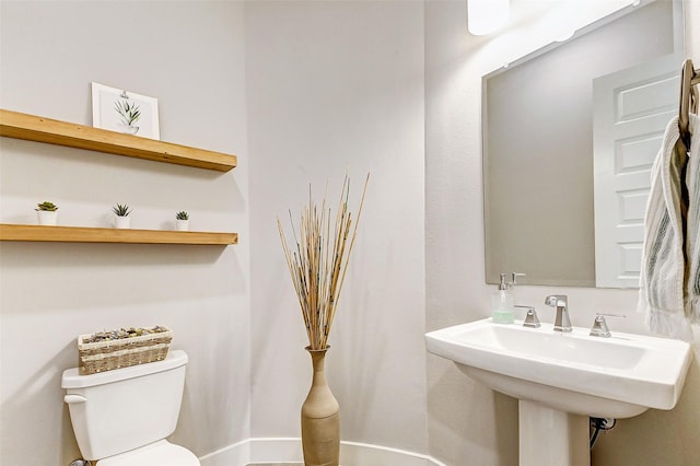 bathroom featuring sink and toilet