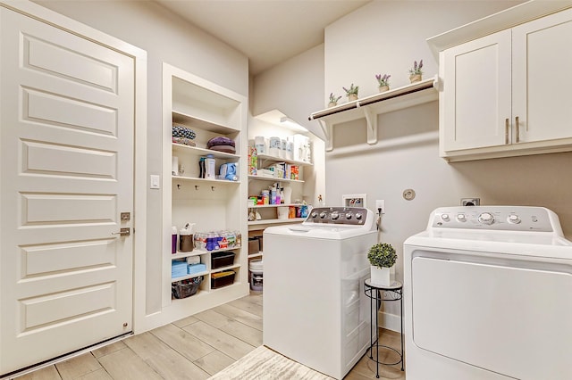 laundry room featuring cabinets and washing machine and dryer