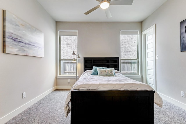 carpeted bedroom featuring multiple windows and ceiling fan