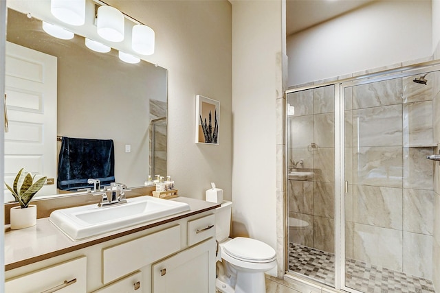 bathroom with vanity, an enclosed shower, and toilet