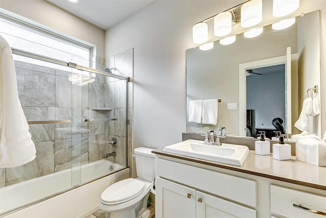 full bathroom featuring vanity, toilet, and combined bath / shower with glass door