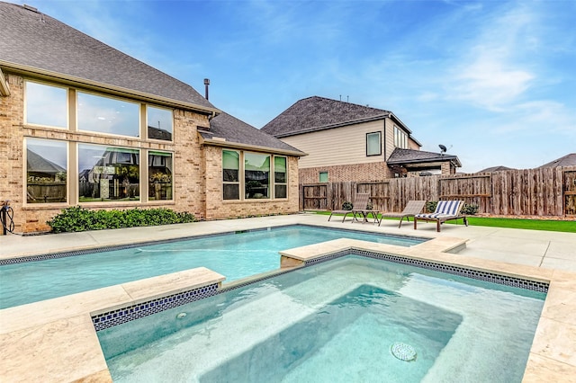 view of swimming pool with a patio area and an in ground hot tub