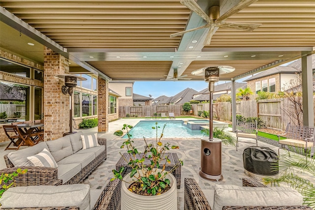 view of swimming pool with an in ground hot tub, ceiling fan, outdoor lounge area, and a patio area