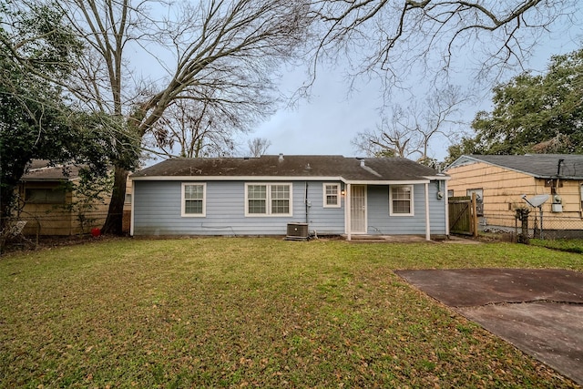 exterior space featuring cooling unit and a front lawn