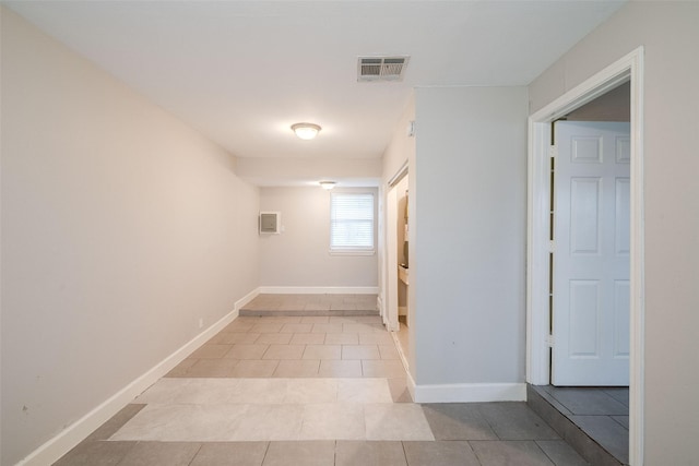 hall featuring light tile patterned floors