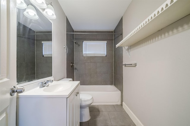 full bathroom featuring vanity, tiled shower / bath, tile patterned floors, and toilet