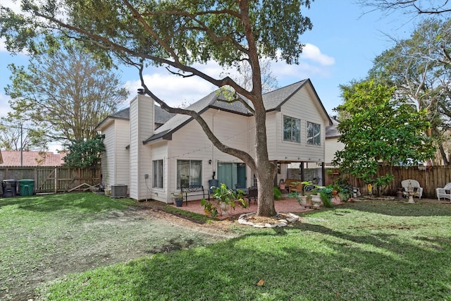 rear view of house featuring a patio area and a lawn