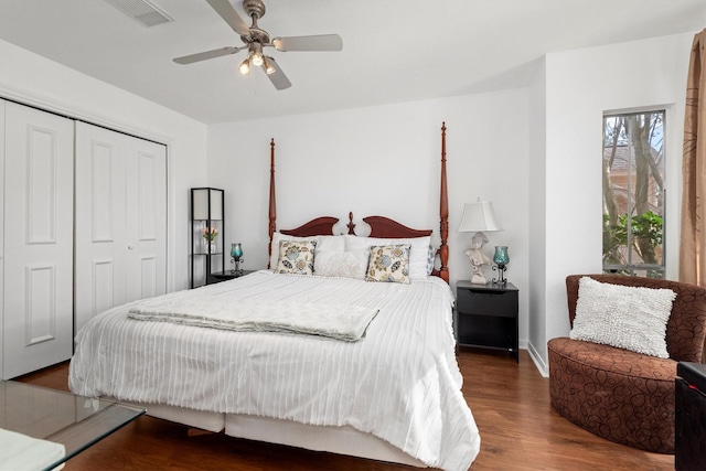 bedroom featuring dark hardwood / wood-style floors, ceiling fan, and a closet