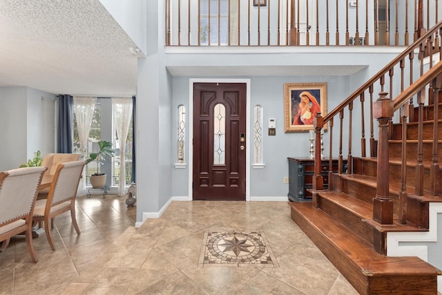 entryway featuring a textured ceiling and light tile patterned floors