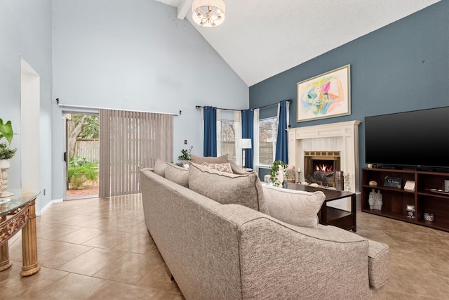 living room with a tiled fireplace, light tile patterned floors, a wealth of natural light, and high vaulted ceiling