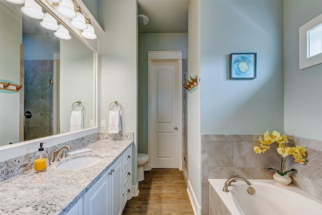 full bathroom with vanity, toilet, wood-type flooring, and plus walk in shower