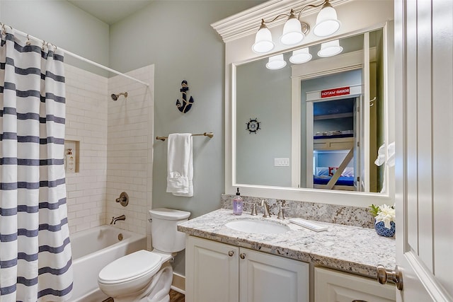 full bathroom featuring shower / tub combo with curtain, vanity, and toilet