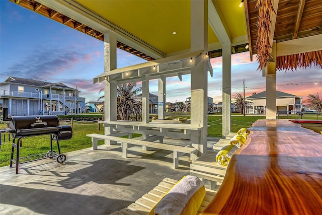 view of home's community featuring a patio area and a lawn