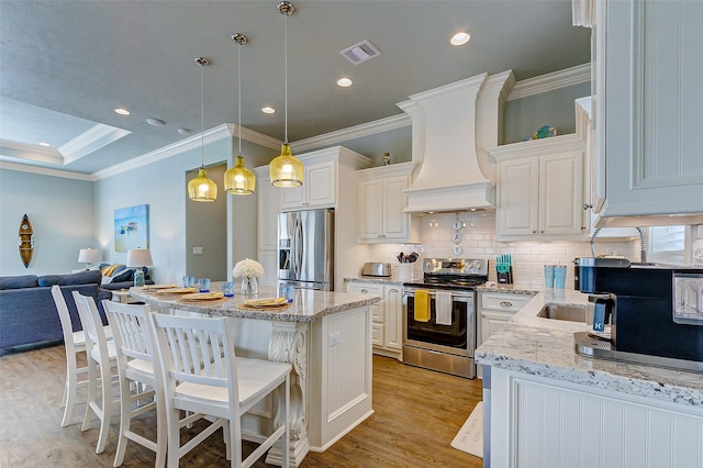 kitchen with a kitchen island, decorative light fixtures, white cabinetry, custom exhaust hood, and stainless steel appliances