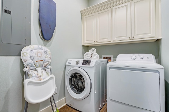 washroom with cabinets and washing machine and clothes dryer