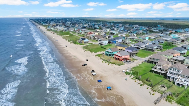 bird's eye view with a water view and a beach view