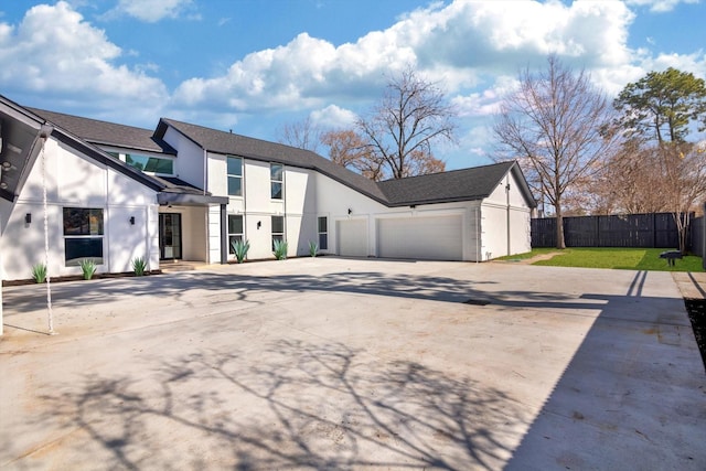 view of front of property with a garage and a front lawn