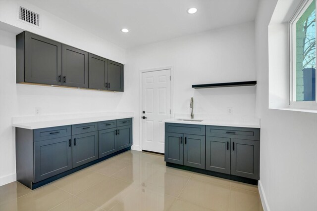 washroom with sink and light tile patterned floors