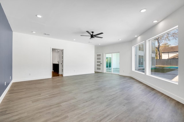 unfurnished room featuring hardwood / wood-style flooring and ceiling fan