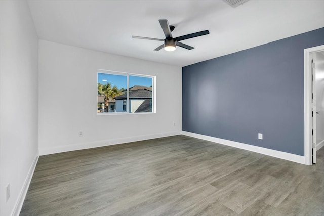 spare room with ceiling fan and wood-type flooring