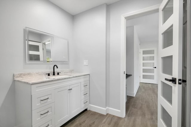 bathroom with wood-type flooring and vanity