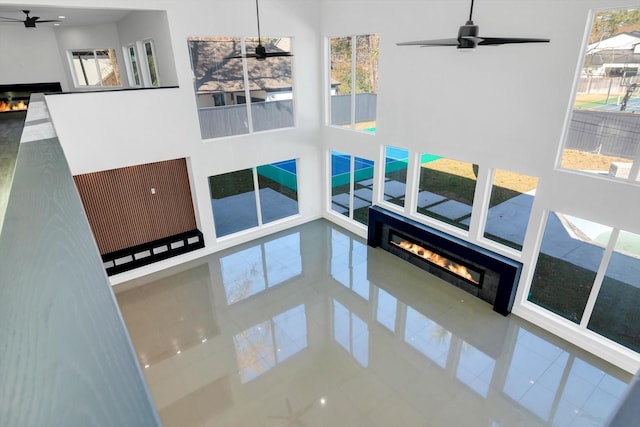 living room featuring a high ceiling and ceiling fan