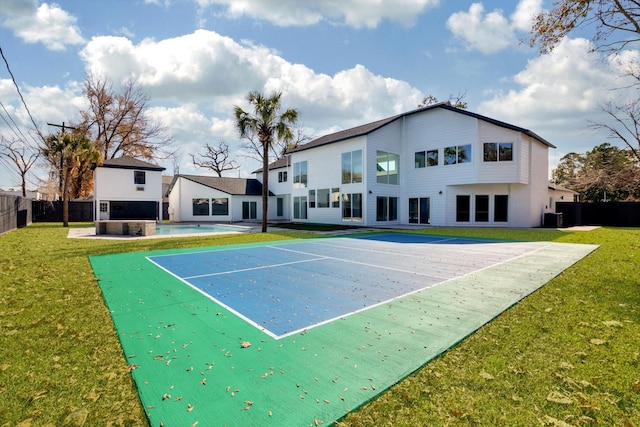 view of sport court with a yard and a covered pool