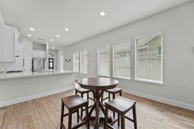 dining area featuring a wealth of natural light and light hardwood / wood-style flooring