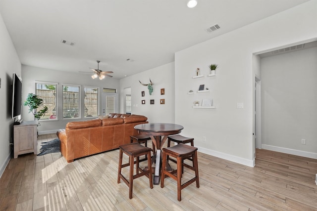 dining room with light hardwood / wood-style flooring and ceiling fan