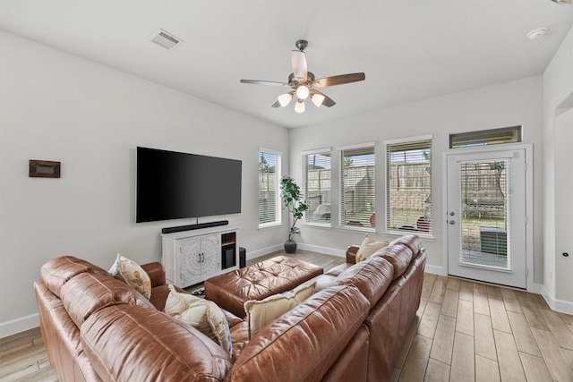 living room with ceiling fan and light hardwood / wood-style flooring