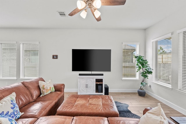 living room featuring ceiling fan and light wood-type flooring