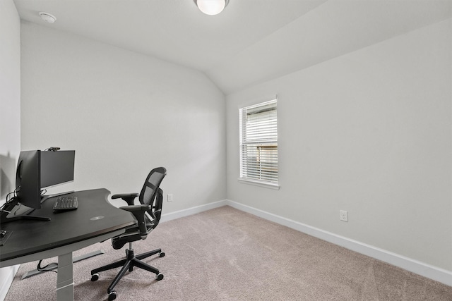 home office featuring vaulted ceiling and light colored carpet