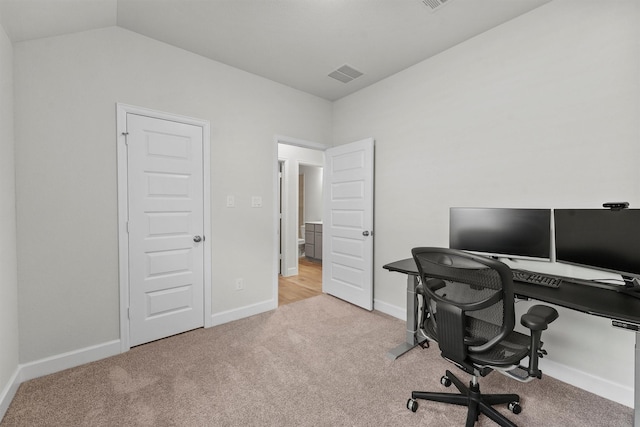 office featuring vaulted ceiling and light colored carpet