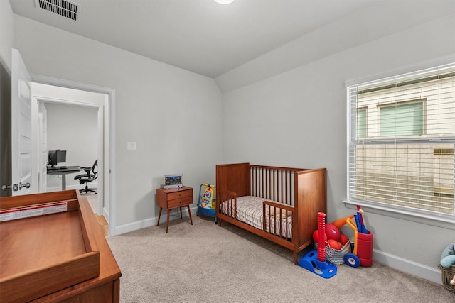 bedroom featuring lofted ceiling and carpet floors