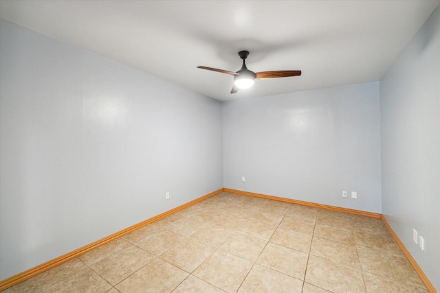 tiled spare room with ceiling fan