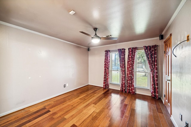 spare room with crown molding, ceiling fan, and wood-type flooring