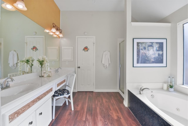 bathroom featuring vanity, hardwood / wood-style flooring, and shower with separate bathtub